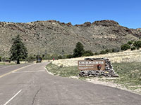 View at the park road entrance sign to Chiricahua National Monument in the grasslands of lower Bonita Canyon.